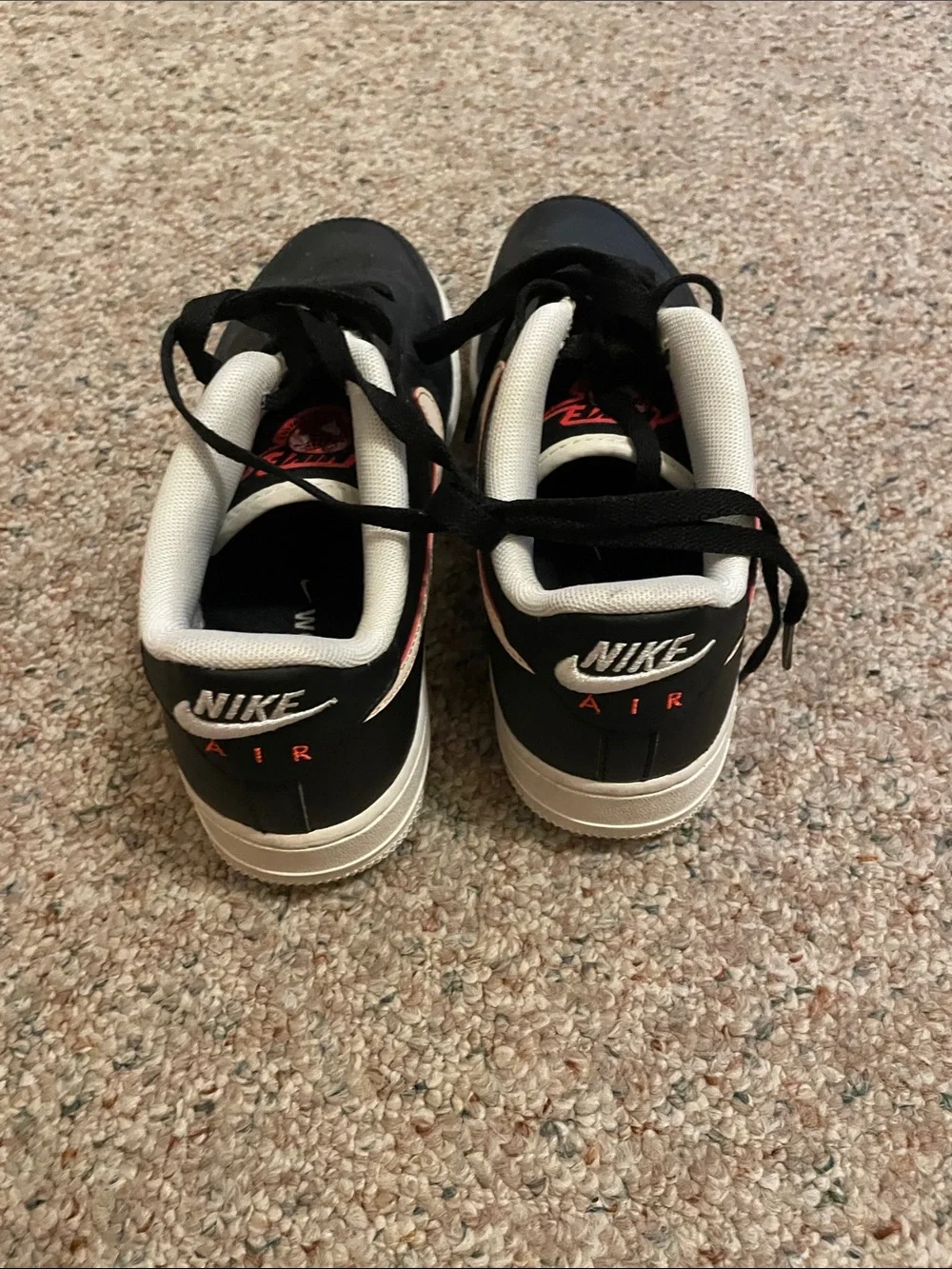 Nike Kids Black Sneakers with Cream Swoosh and Orange Accents